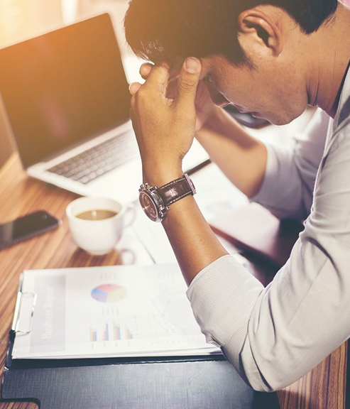Stressed professional at laptop
